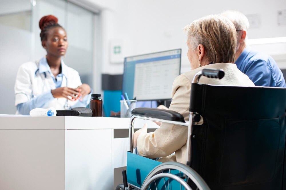 Woman in wheelchair consults with doctor